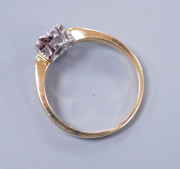 A modern 18ct gold and seven stone diamond set flower head cluster ring, size L, gross weight 2.9 grams